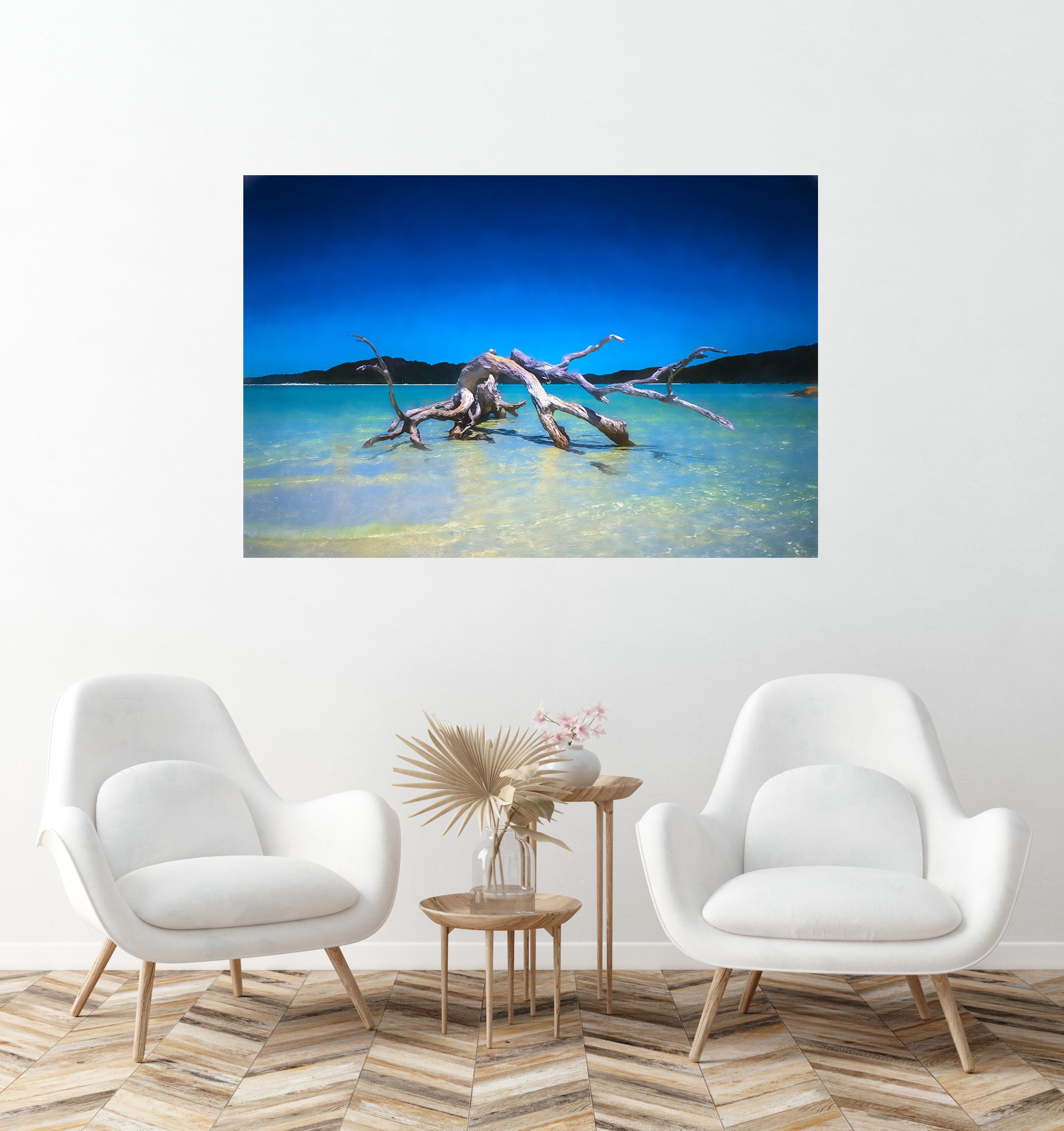 A large canvas print of a bleached driftwood tree standing in shallow turquoise water, hung above a bed.